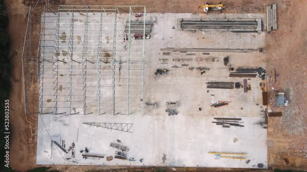 Construction of a large warehouse from metal structures. Assembly of an industrial hangar or factory on a steel frame. Logistic building for storage of products, products, goods. UHD 4K. Construction of a large warehouse from metal structures. Assembly of an industrial hangar or factory on a steel frame. Logistic building for storage of products, products, goods. UHD 4K.