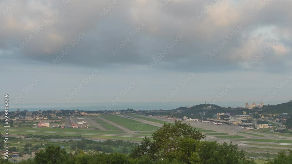 Panoramic view of the airfield, runway and airport. Daytime traffic at a busy airport. Time lapse of planes taking off and landing Panoramic view of the airfield, runway and airport. Daytime traffic at a busy airport. Time lapse of planes taking off and landing