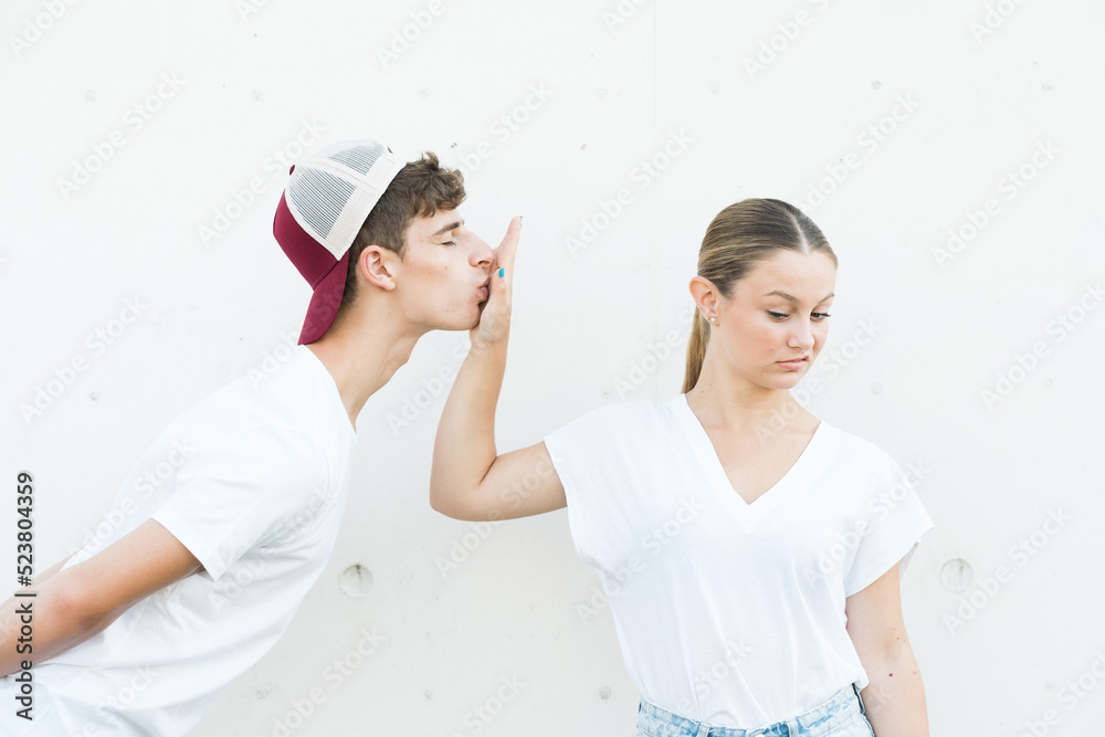 Displeased teenager girl rejecting kiss or relationship. Halitosis concept Displeased teenager girl rejecting kiss or relationship. Halitosis concept
