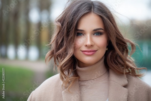 Fashionable female model face. Beautiful brunette outdoor