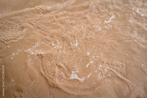 Fotografia Muddy strong water inundation from the hill side due to heavy storm weather, Disaster scene photo