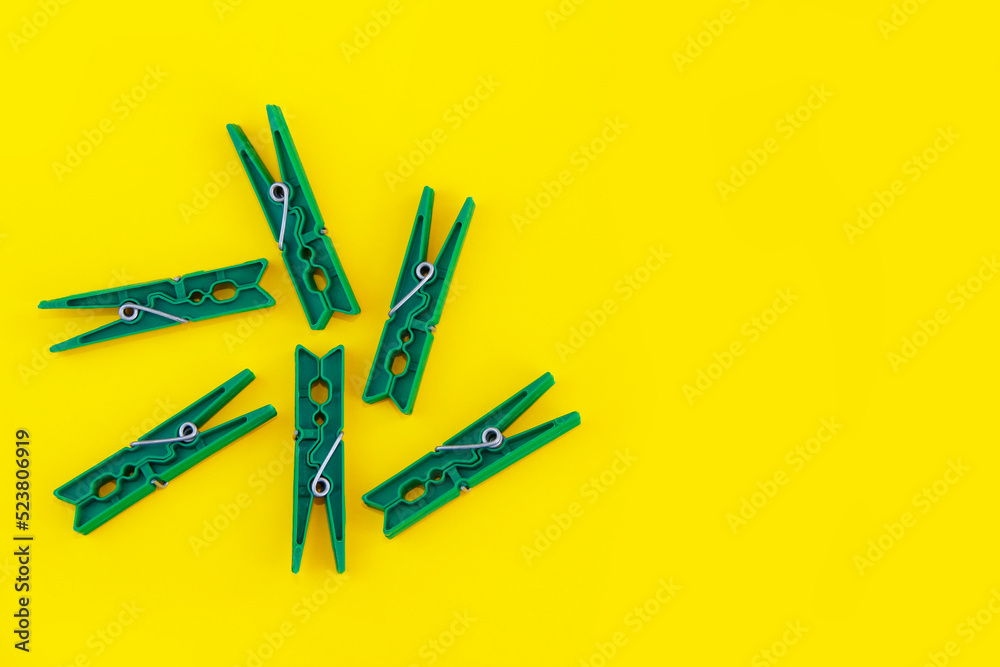 plastic clothespins for fastening laundry, on a yellow background plastic clothespins for fastening laundry, on a yellow background