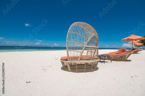 Beautiful rattan chair at an upscale white sand beachfront resort in Dumaluan Beach, Panglao Island, Bohol, Philippines. photo