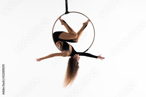 Slim and flexible circus Girl In aerial hoop isolated On White Background