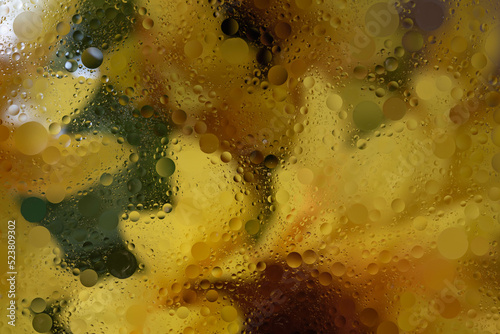 Background abstract. Bright and colorful oil and water abstract background with greens, oranges, yellows and white.