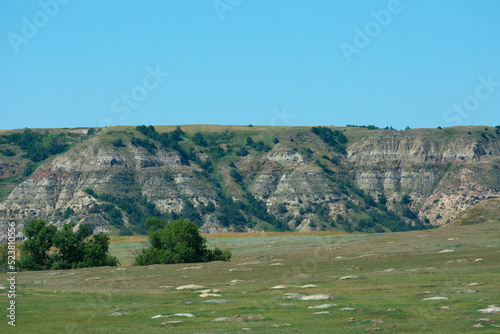 Multi colored and layered rock hills at Theodore Roosevelt National Park photo