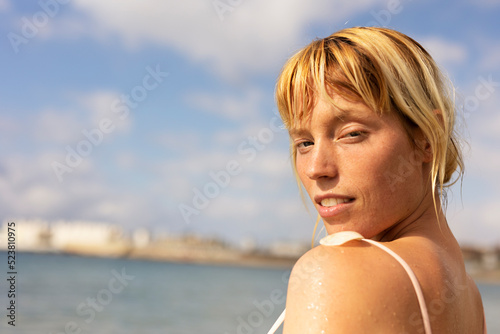  Beautiful woman swimming in the ocean. Smiling blonde girl enjoy in sunny day