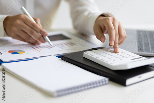 Businesswoman accountant or financial expert analyze business report graph and finance budget chart in the office. Concept of finance economy  banking business and stock market research.