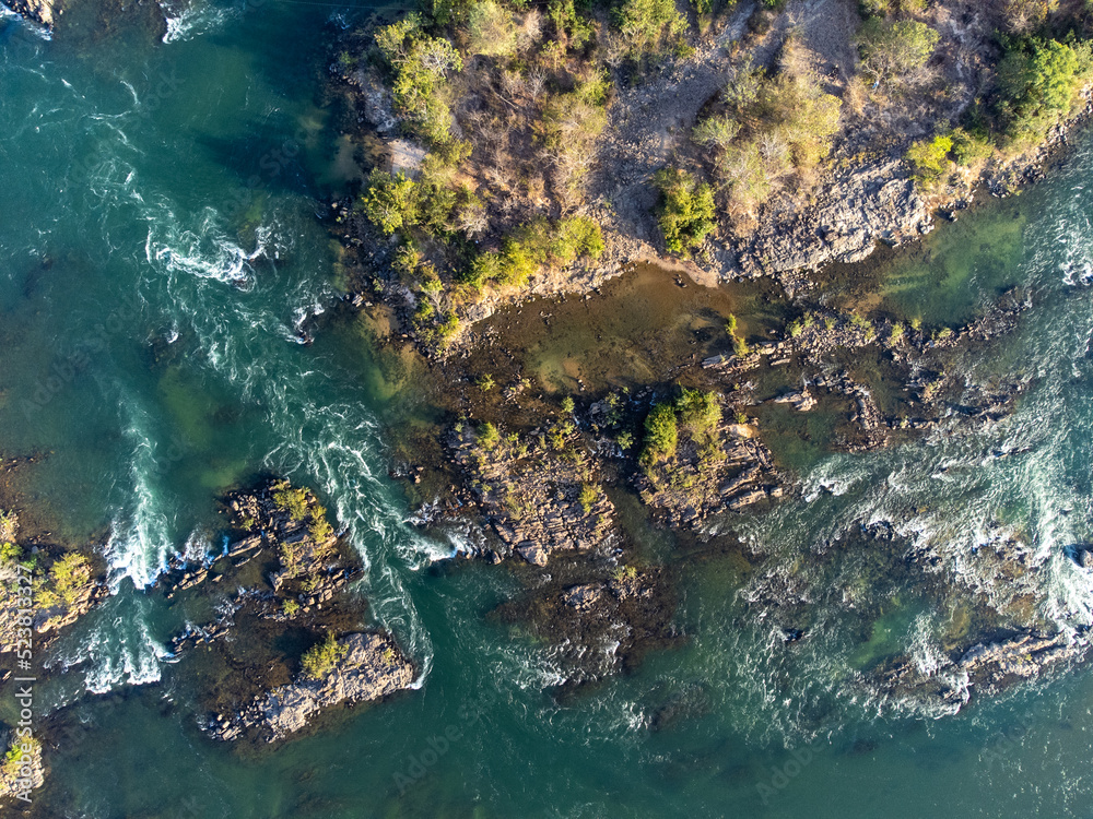 river bird top view with rocks, sand and forest