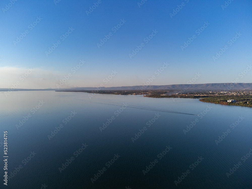 Green piece of land with trees on the banks of the great lake of the Tocantins River in Palmas