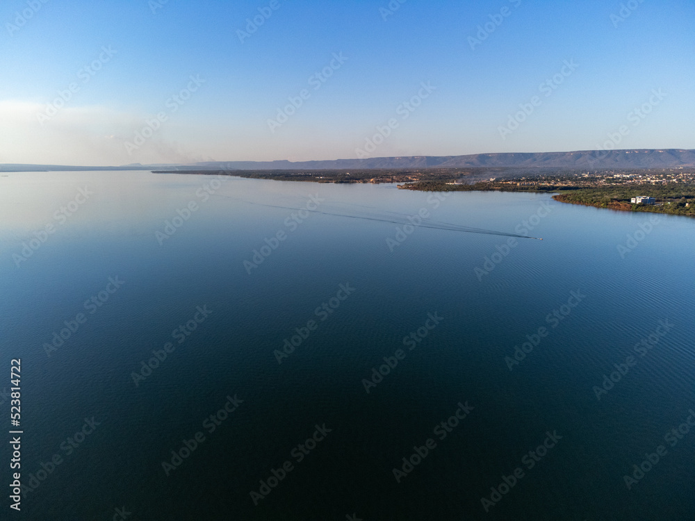 Green piece of land with trees on the banks of the great lake of the Tocantins River in Palmas