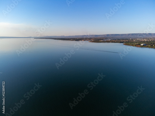 Green piece of land with trees on the banks of the great lake of the Tocantins River in Palmas