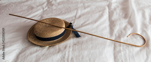 Vintage school cane, once used for corporal punishment of school students. Vintage school boater once worn by schoolgirls.
