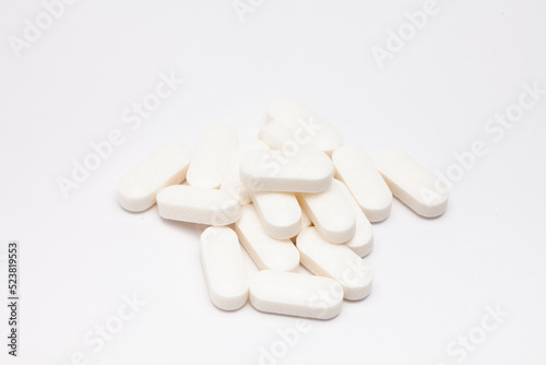 Pills drugs tablets vitamins macro image on white background
