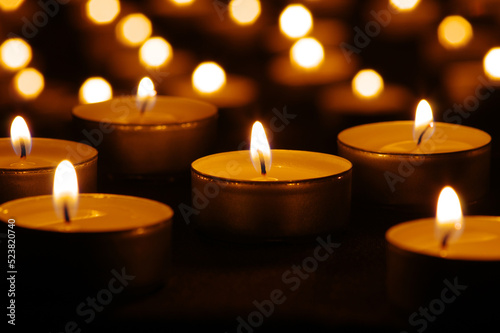 Many burning candles with bokeh light background