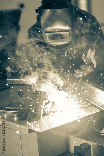 Fototapeta Naklejka Na Ścianę i Meble -  welder performing his work at a stationary post for electric arc welding