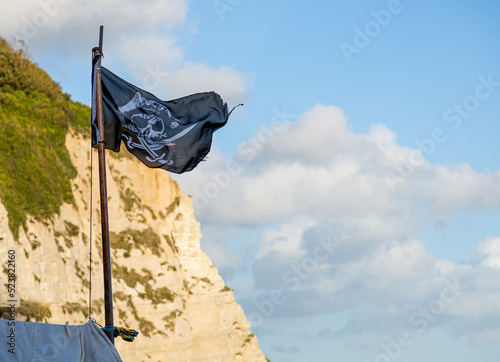 A dastardly skull and crossbones pirate flag waving in the wind. Calico Jack. photo