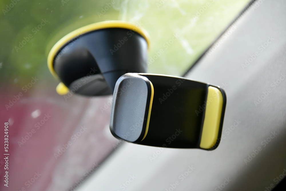 Mobile phone holder on the windshield of the car. Mobile phone holder on the windshield of the car.