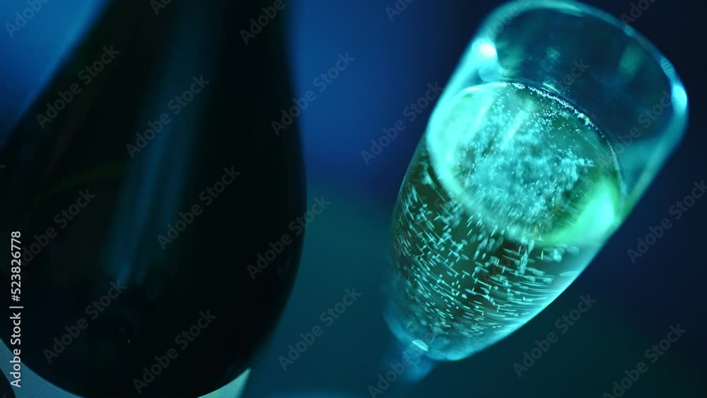 Glass of champagne and a bottle in the club. Glass of champagne and a bottle in the club.