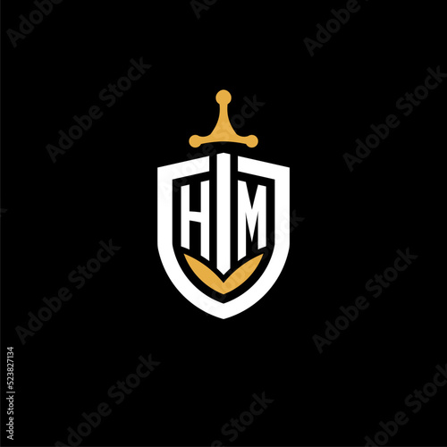 Creative letter HM logo gaming esport with shield and sword design ideas