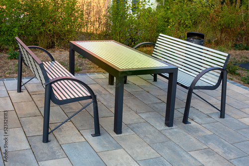 set of a table and two modern style benches outdoors © wernerimages