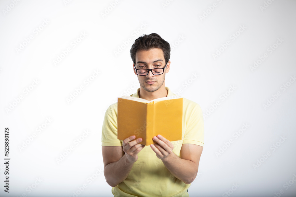 Portrait of student reading book and sleeping isolated on white Portrait of student reading book and sleeping isolated on white