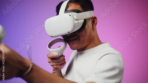 Korean man using virtual reality glasses, playing video games, Asian guy wearing new generation gaming headset for entertainment, amusement park, future technology concept.