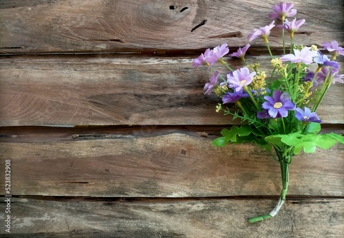 Bouquet of flowers on wood background 