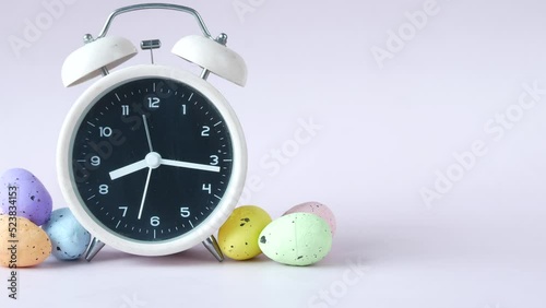 easter concept with egg and a clock on table 