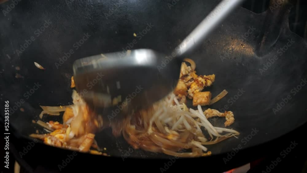 Slow motion video pad Thai in hot pan, popular street food in Thailand.