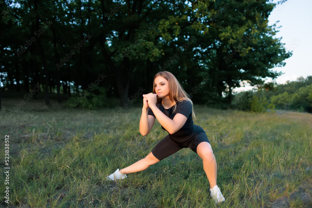 athletic blonde doing squats with stretching legs to the side athletic blonde doing squats with stretching legs to the side