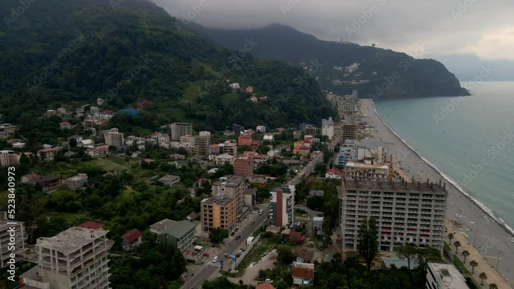 Drone flying over the city of Gonio on a rainy day. Fog shrouds the mountains, lush greenery grows on the slopes. Drone flying over the city of Gonio on a rainy day. Fog shrouds the mountains, lush greenery grows on the slopes.
