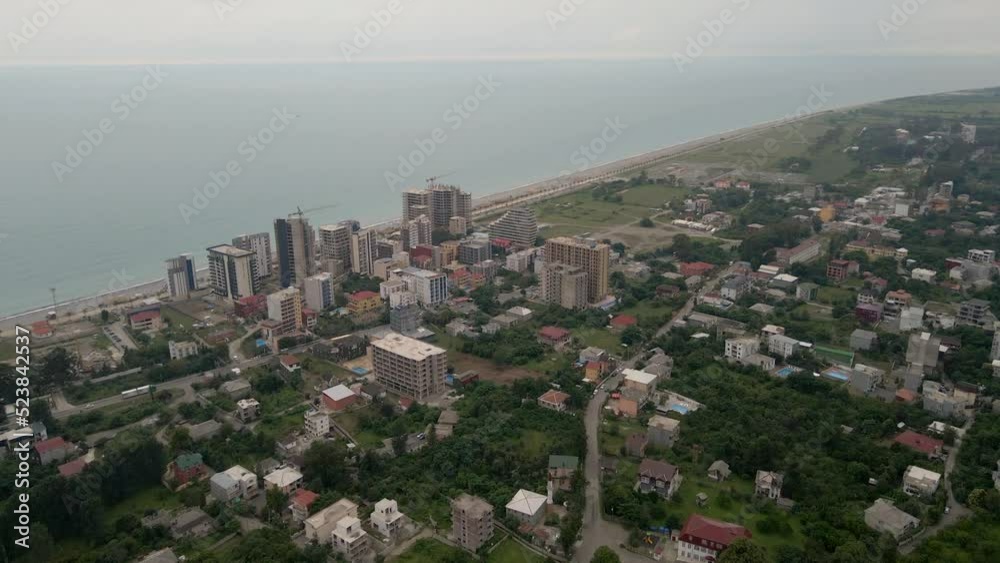 Drone flying over the city of Gonio on a rainy day. Fog shrouds the mountains, lush greenery grows on the slopes. Drone flying over the city of Gonio on a rainy day. Fog shrouds the mountains, lush greenery grows on the slopes.