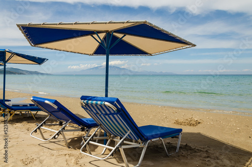 Sun loungers and umbrella looking out from the beach at Alykes to Kefalonia