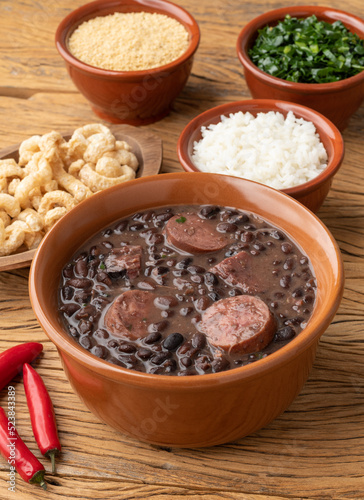 Typical brazilian feijoada with rice, kale, farofa and cracklings