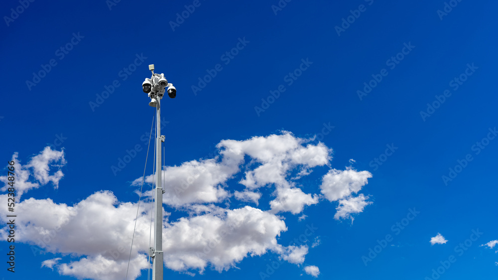 Low angle view of a CCTV mobile camera with clouds and blue sky