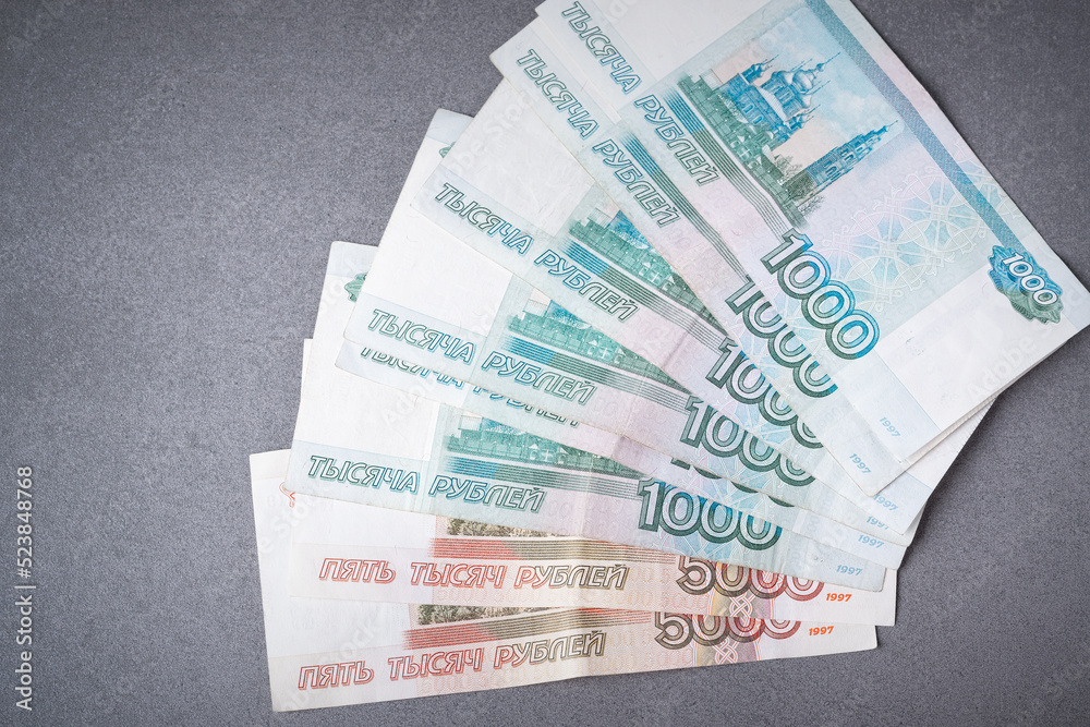 Russian rubles on a grey background. Russian rubles, currency, banknotes. Financial crisis, ruble devaluation concept. Top view, flat lay Russian rubles on a grey background. Russian rubles, currency, banknotes. Financial crisis, ruble devaluation concept. Top view, flat lay