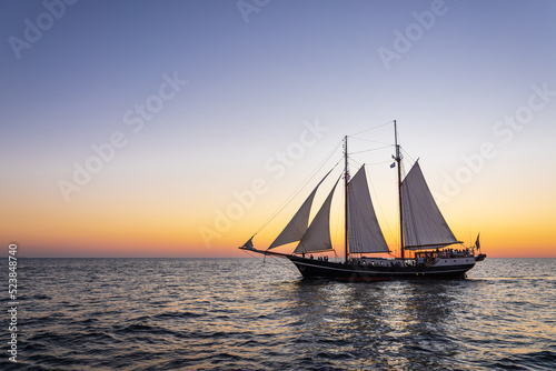Segelschiff im Sonnenuntergang auf der Hanse Sail in Rostock photo