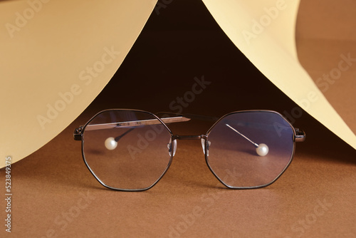 eye glasses on paper brown and beige background, vision concept