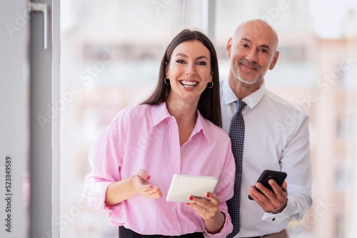 Group of business people standing at the office while working together photo