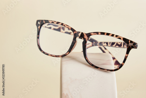 fashion eyeglass frames, glasses on ceramic podium, creative presentation of eyeglasses
