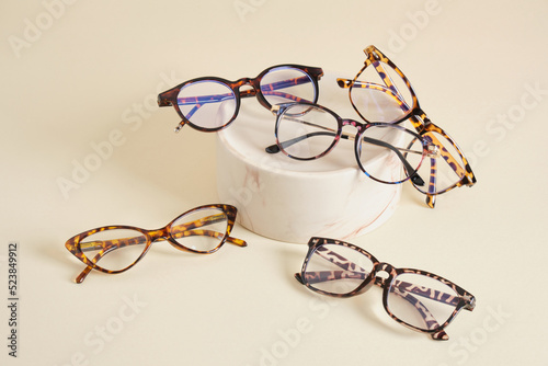 fashion eyeglass frames, glasses on ceramic podium, creative presentation of eyeglasses