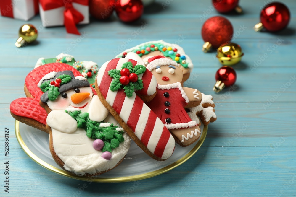 Sweet Christmas cookies and decor on light blue wooden table
