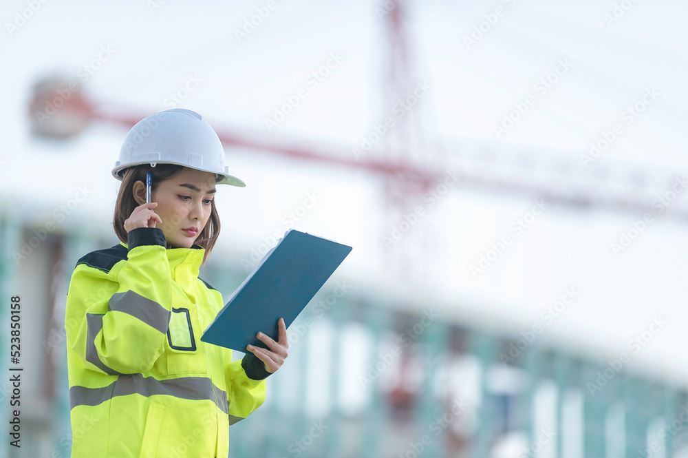 Asian engineer working at site of a large building project,Thailand people,Work overtime at construction site Asian engineer working at site of a large building project,Thailand people,Work overtime at construction site