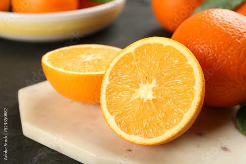 Delicious ripe oranges on white board, closeup
