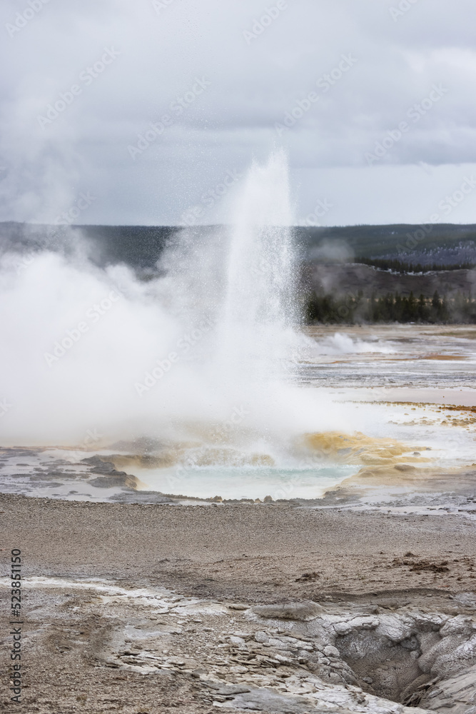 Hot spring Geyser with colorful water in American Landscape. Yellowstone National Park, Wyoming, United States. Nature Background. Hot spring Geyser with colorful water in American Landscape. Yellowstone National Park, Wyoming, United States. Nature Background.