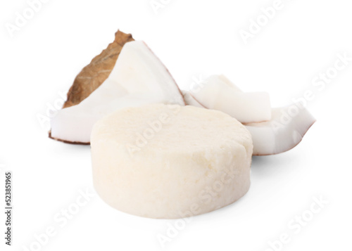 Solid shampoo bar and coconut pieces on white background. Hair care