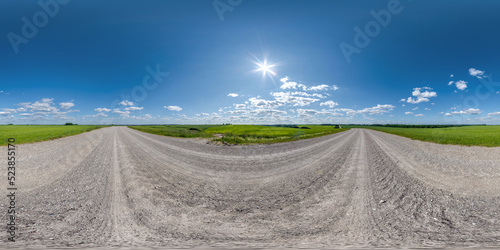 360 hdri panorama on no traffic gravel dusty white sand road among fields with fluffy clouds in full seamless spherical equirectangular projection, may use like sky replacement for drone panorama