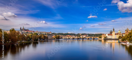 Prague's cityscape with the Charles Bridge above the Vltava River with the buildings of the Prague Castle in the background © petertakacs