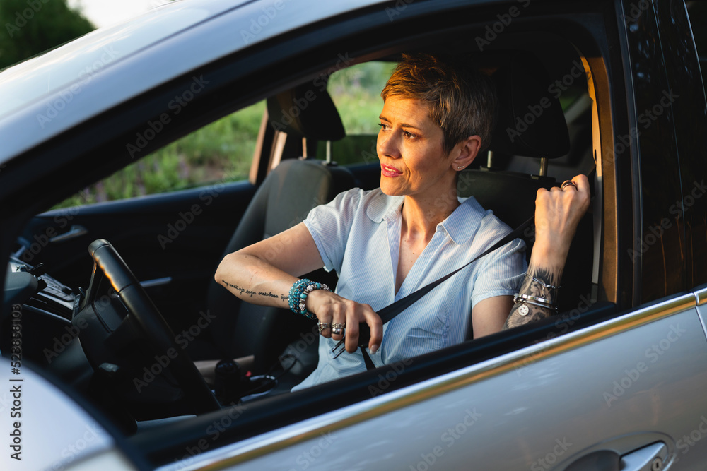 Woman driver caucasian female fastening seat belt safety concept Woman driver caucasian female fastening seat belt safety concept